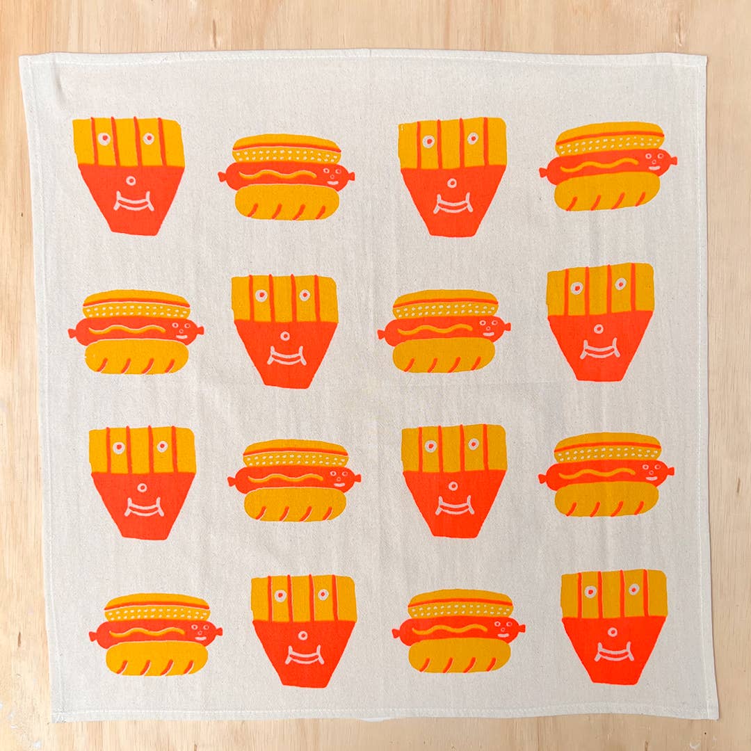 Fabric with colorful hot dog and french fry pattern on a wooden surface