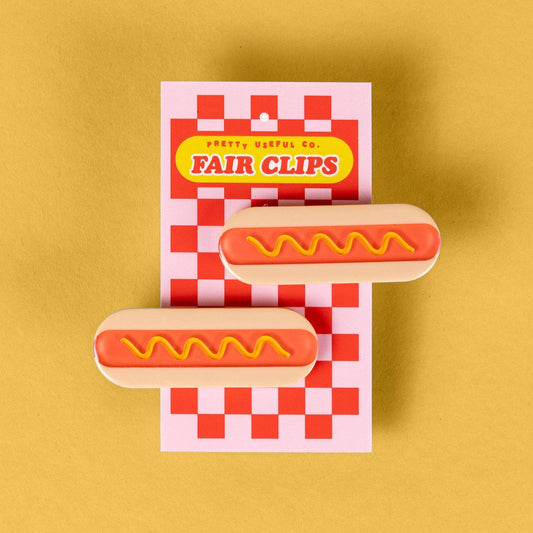 Set of hair clips that each look like hot dogs with a squiggle of mustard on them