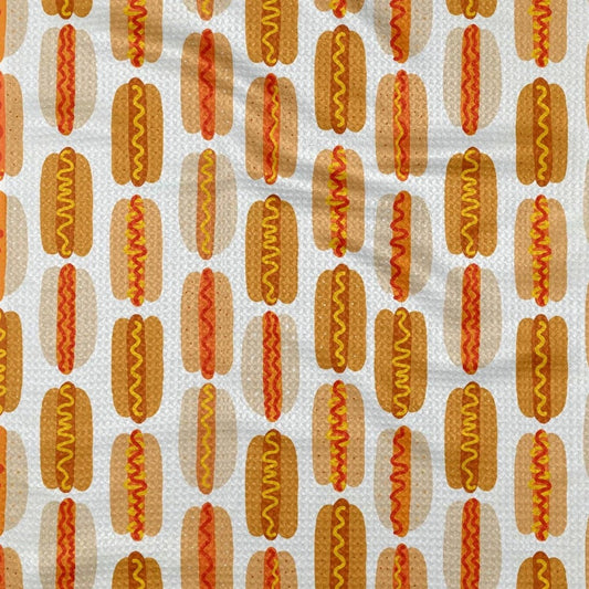 White, weaved kitchen towel with hot dog pattern. Hot dogs have ketchup, mustard or combination of both.