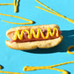 Hot dog candle with mustard from above 