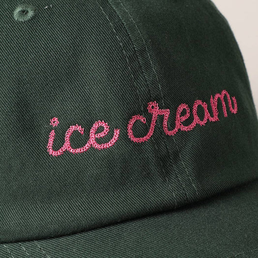 close up details of embroidery on black ice cream hat 