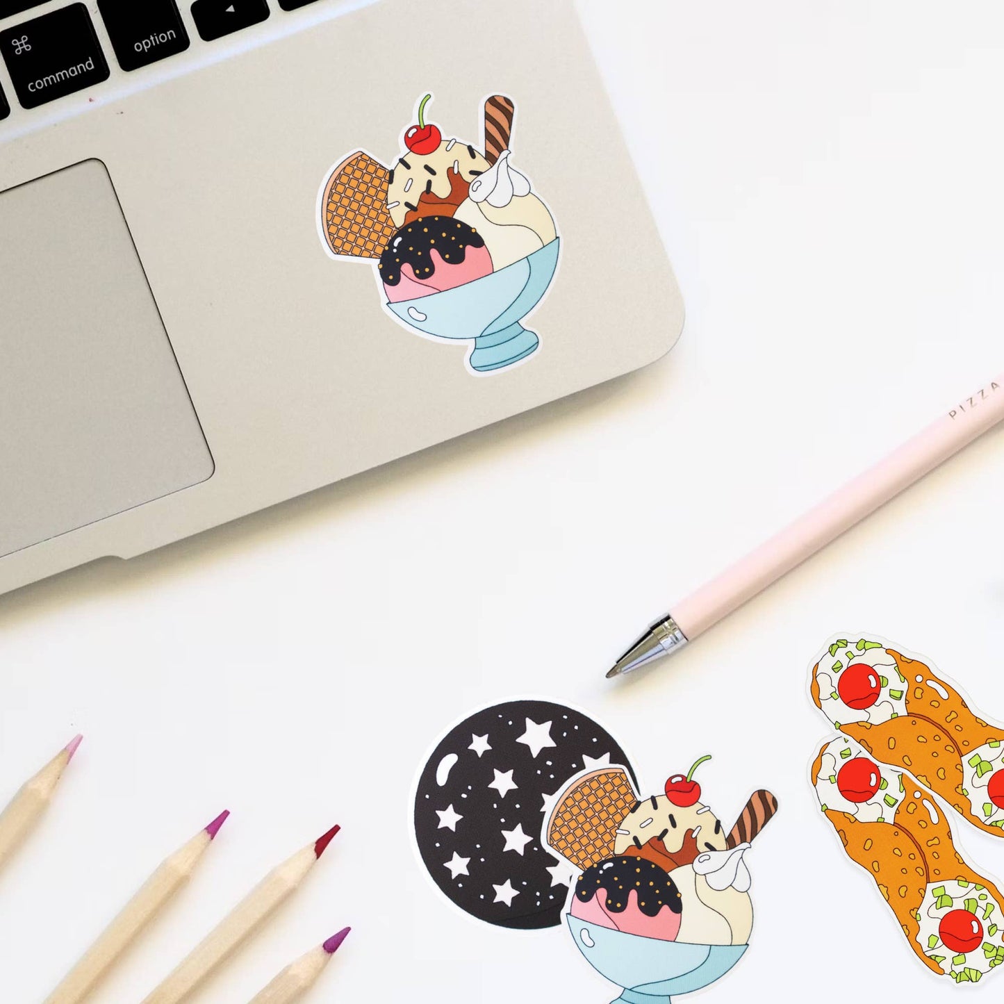 ice cream sundae sticker on laptop -- featuring 3 scoops of ice cream, chocolate, strawberry and vanilla, along with a waffle cone piece, whipped cream, sprinkles and a cherry on top