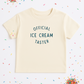 Beige t-shirt with 'Official Ice Cream Taster' text on a white background with colorful sprinkles.
