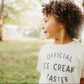 Child wearing a 'Official Ice Cream Taster' shirt outdoors