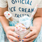 Child holding a colorful ice cream shake with a straw, wearing a shirt that says 'Official Ice Cream Taster'.