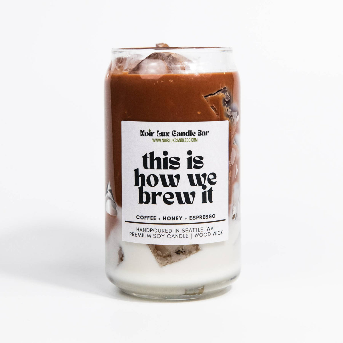 Candle in a glass jar with a label on a white background