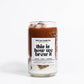 Candle in a glass jar with a label on a white background