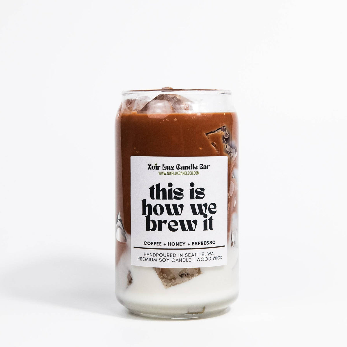 Candle in a glass jar with a label on a white background