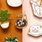 Collection of cute enamel pins on a wooden and pink background