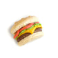 Closeup photo of tiny cheeseburger magnet on white background.