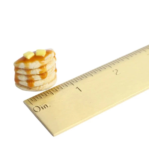 Handmade magnet shaped like stack of five pancakes with syrup and butter on top. Shown next to a ruler for size comparison.