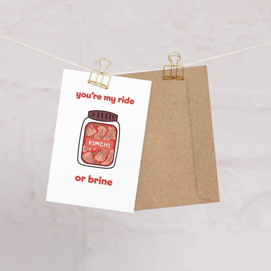 Greeting card with kimchi plastic tub illustration and text 'you're my ride or brine' on a white background