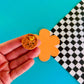 mini smiley faced waffle magnet with a heart-shaped pad of butter and syrup on it