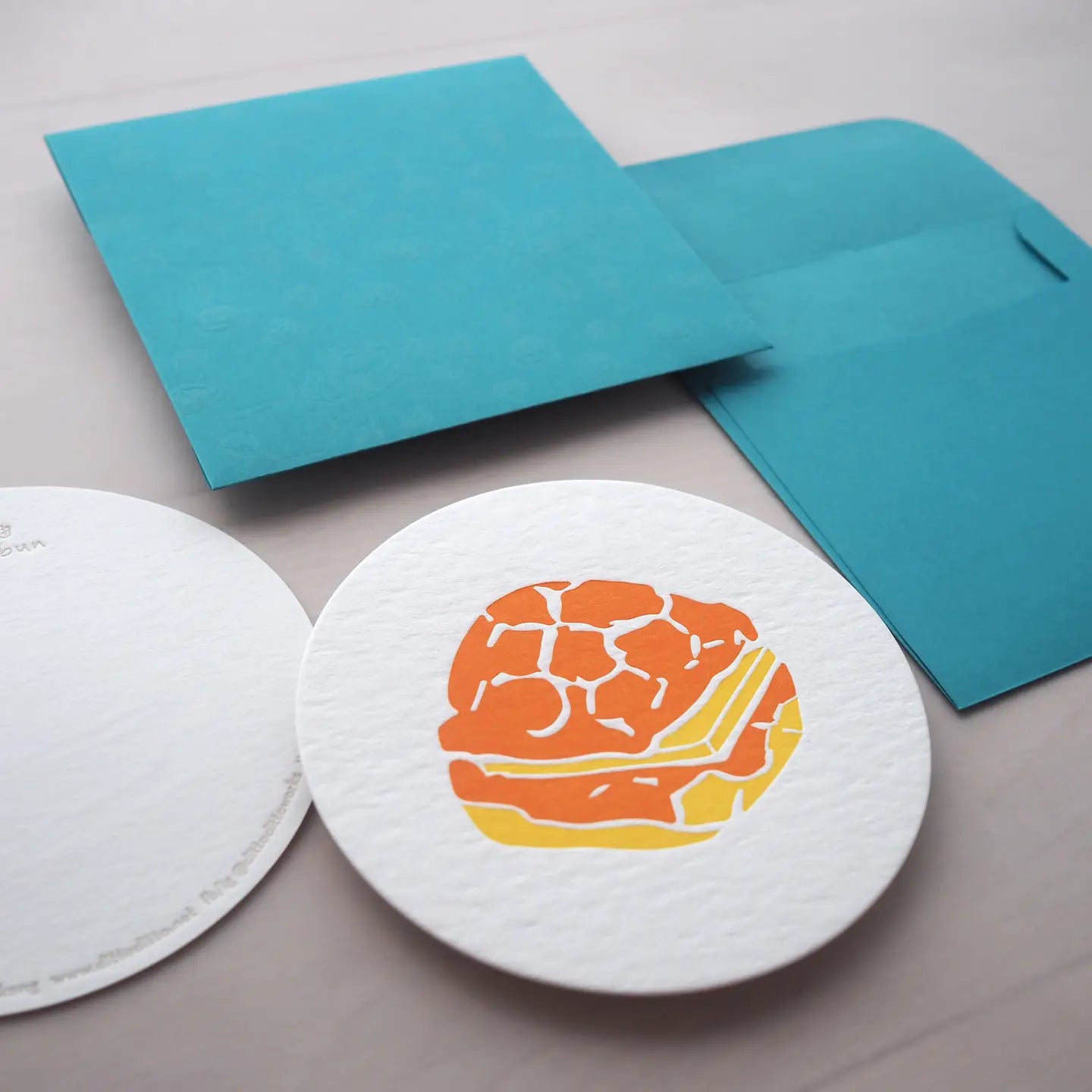 round white notecard with a pineapple design on it. Envelope is turquoise blue