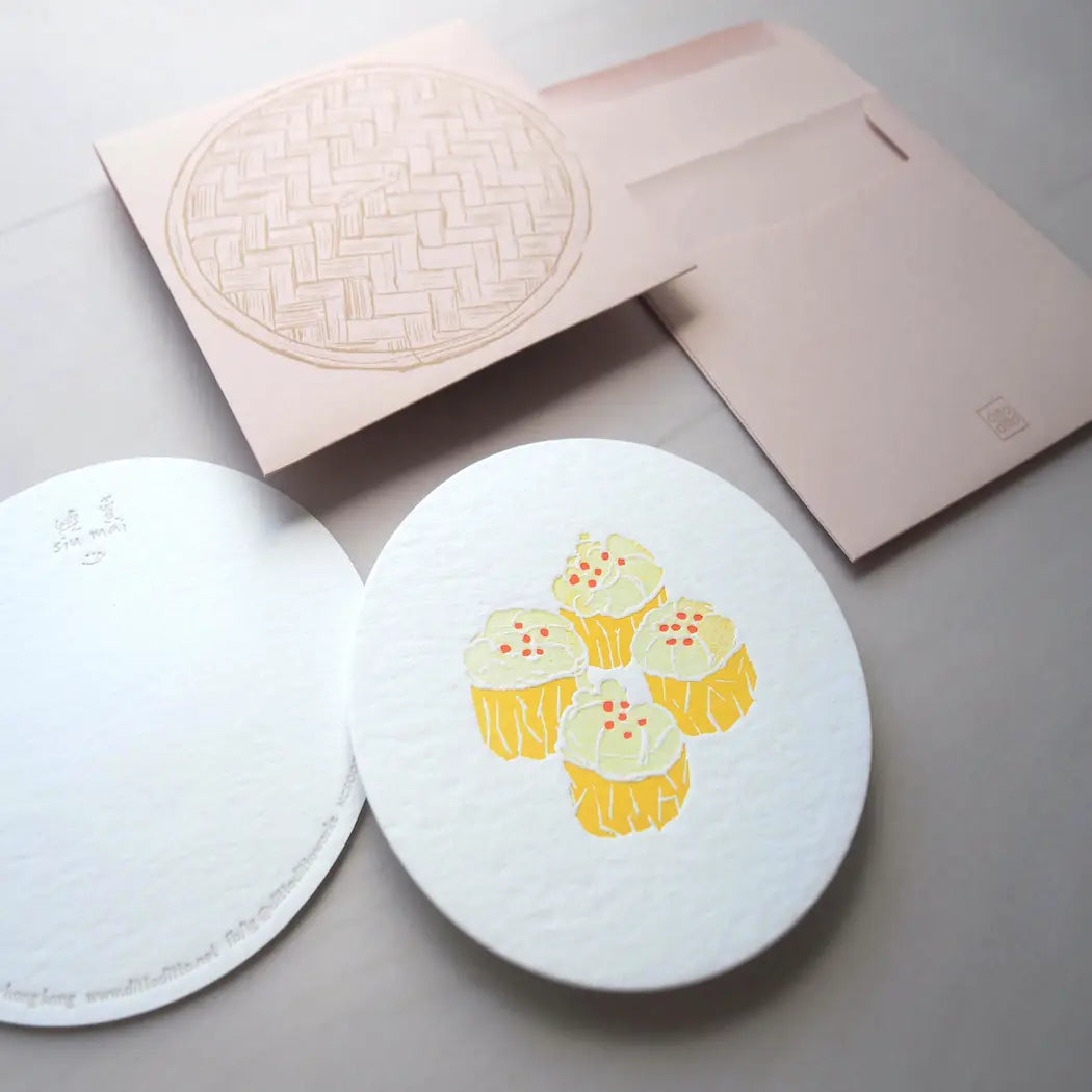 Round notecard with pork dumpling, or siu mai, design. Comes with brown envelope with bamboo steamer design on it. 