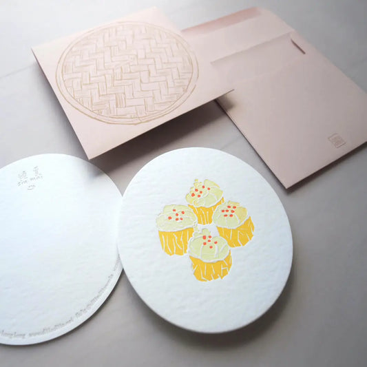 Round notecard with pork dumpling, or siu mai, design. Comes with brown envelope with bamboo steamer design on it. 
