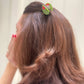 mini olive hair claw holding hair 