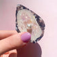 oyster hair claw with pearl detail held in hand 