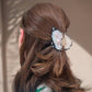 oyster hair claw with pearl detail in hair 