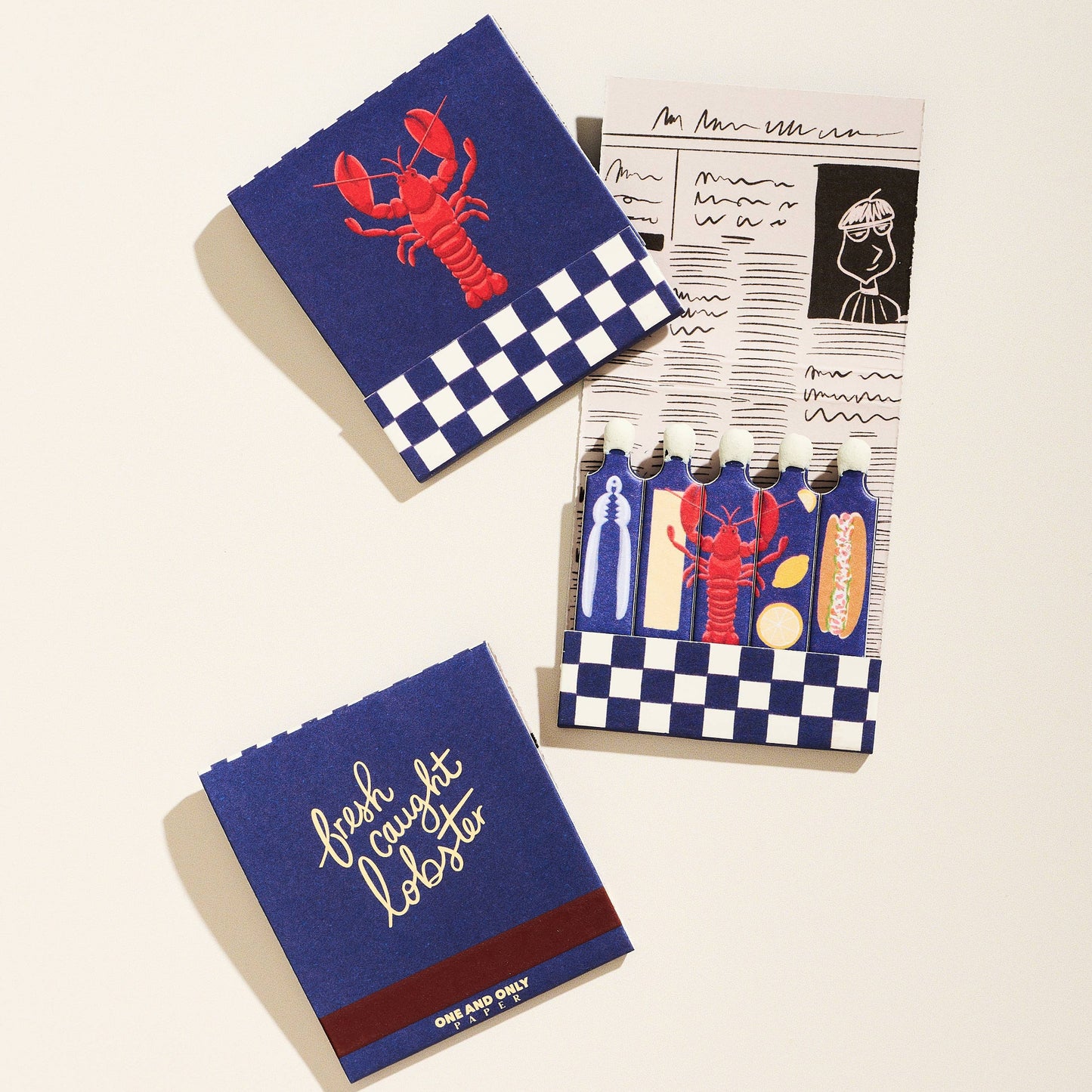 Two matchbooks with red lobster designs on a white background