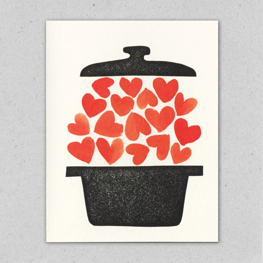 Greeting card with illustration of a grey/black dutch oven style pot with 17 red hearts floating in-between the lid and pot base.