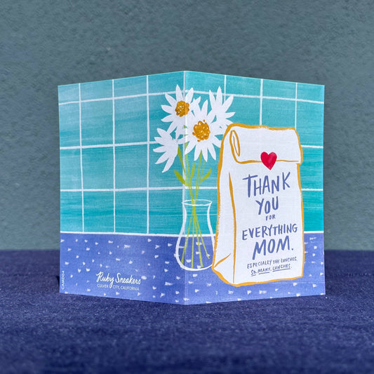 Greeting card with flowers and text on a blue background