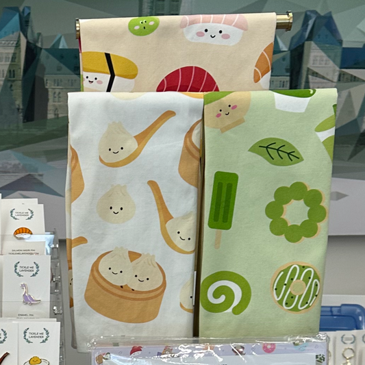 Three patterned towels on a stand with a blurred background