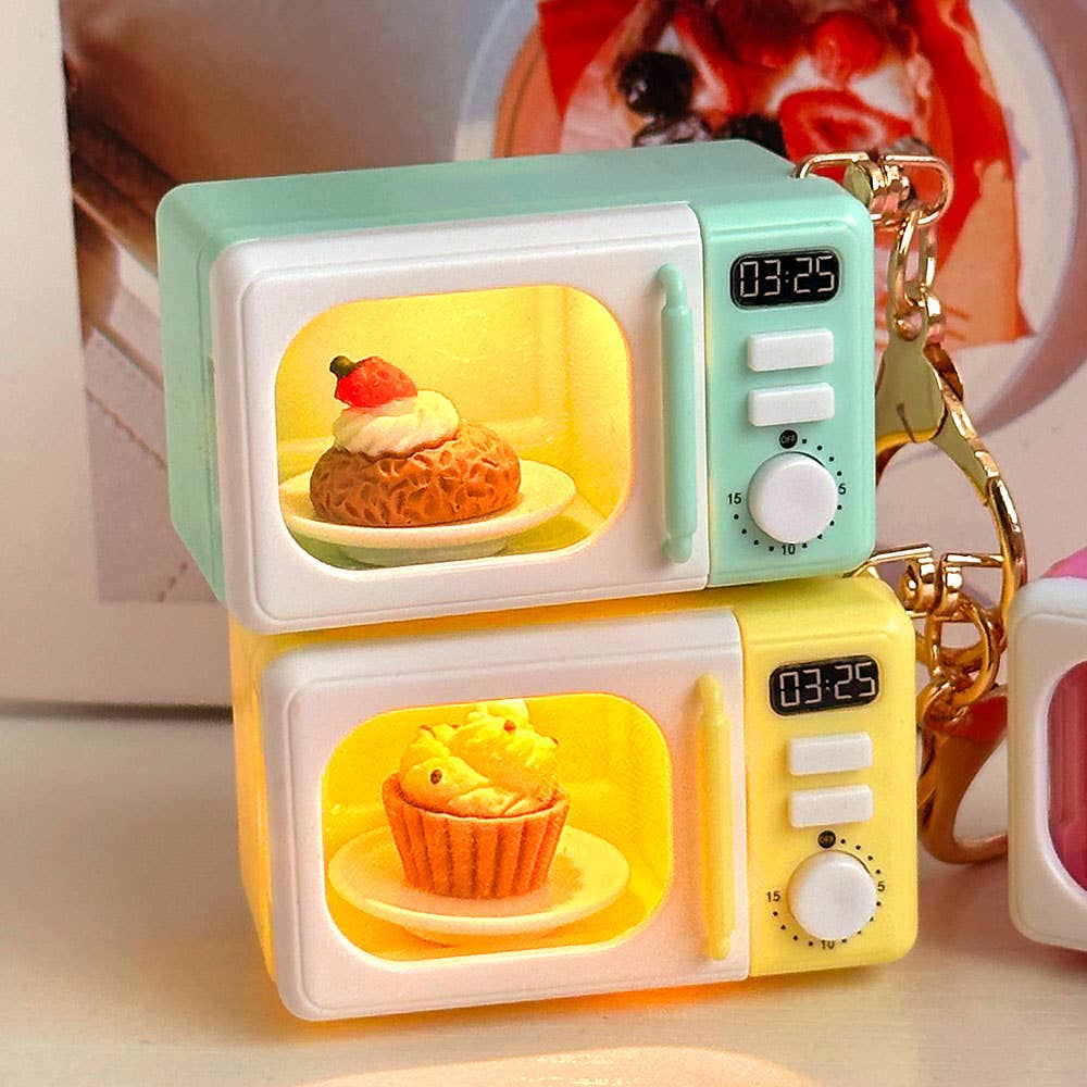 Microwave-shaped keychains with digital display and food illustration on a blurred background