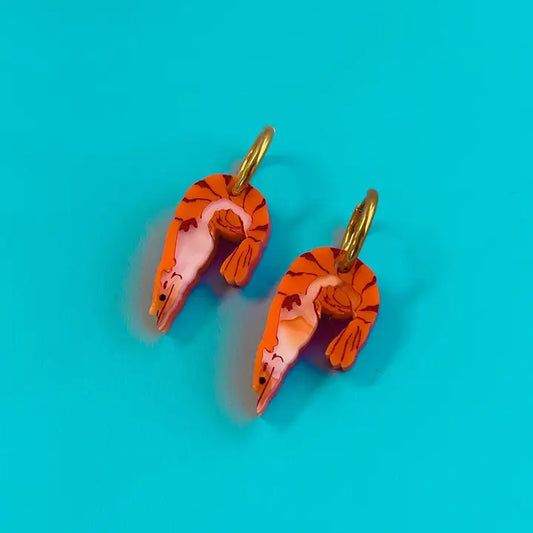 Shrimp earrings on a blue background 