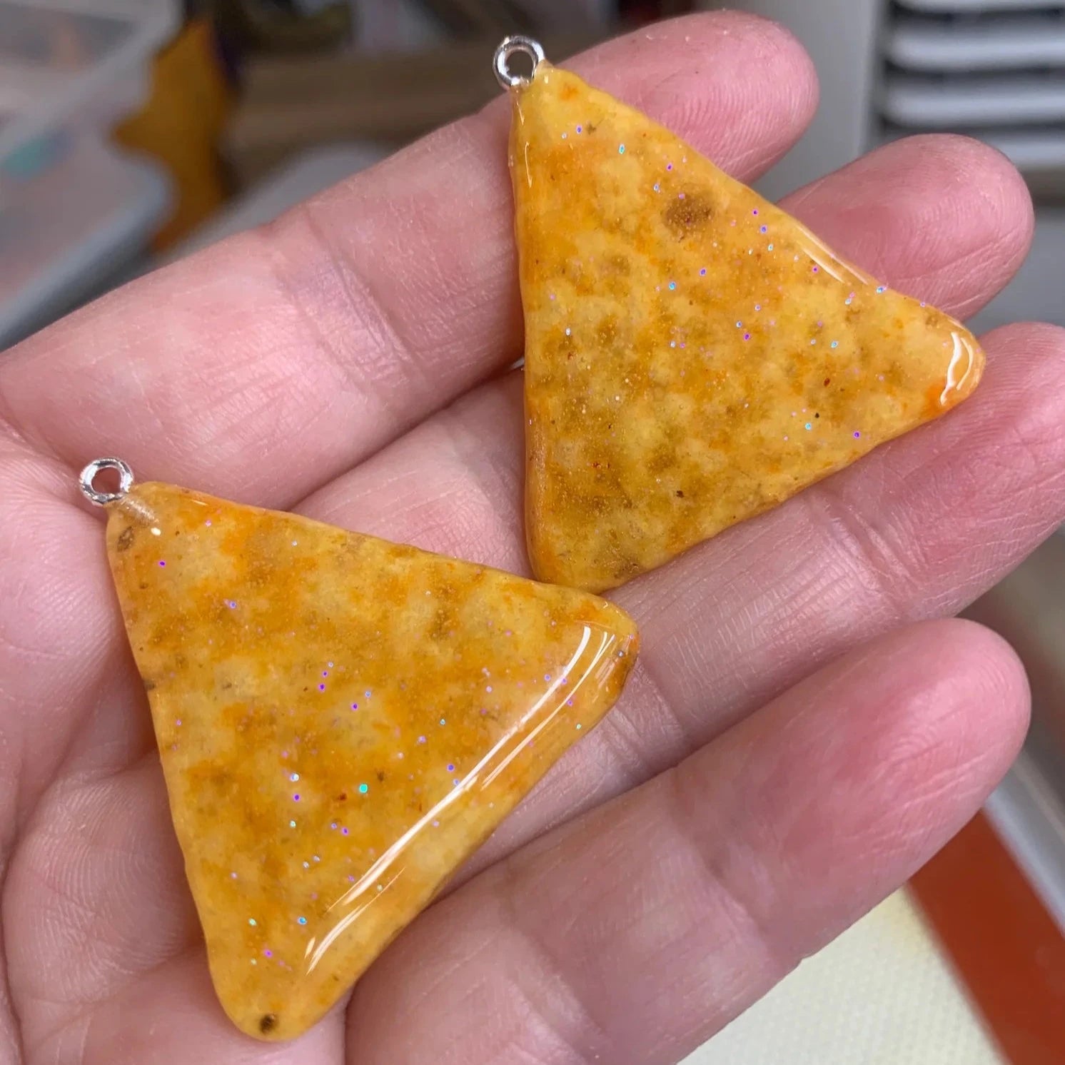 Mini tortilla chips, coated in resin and turned into earrings.