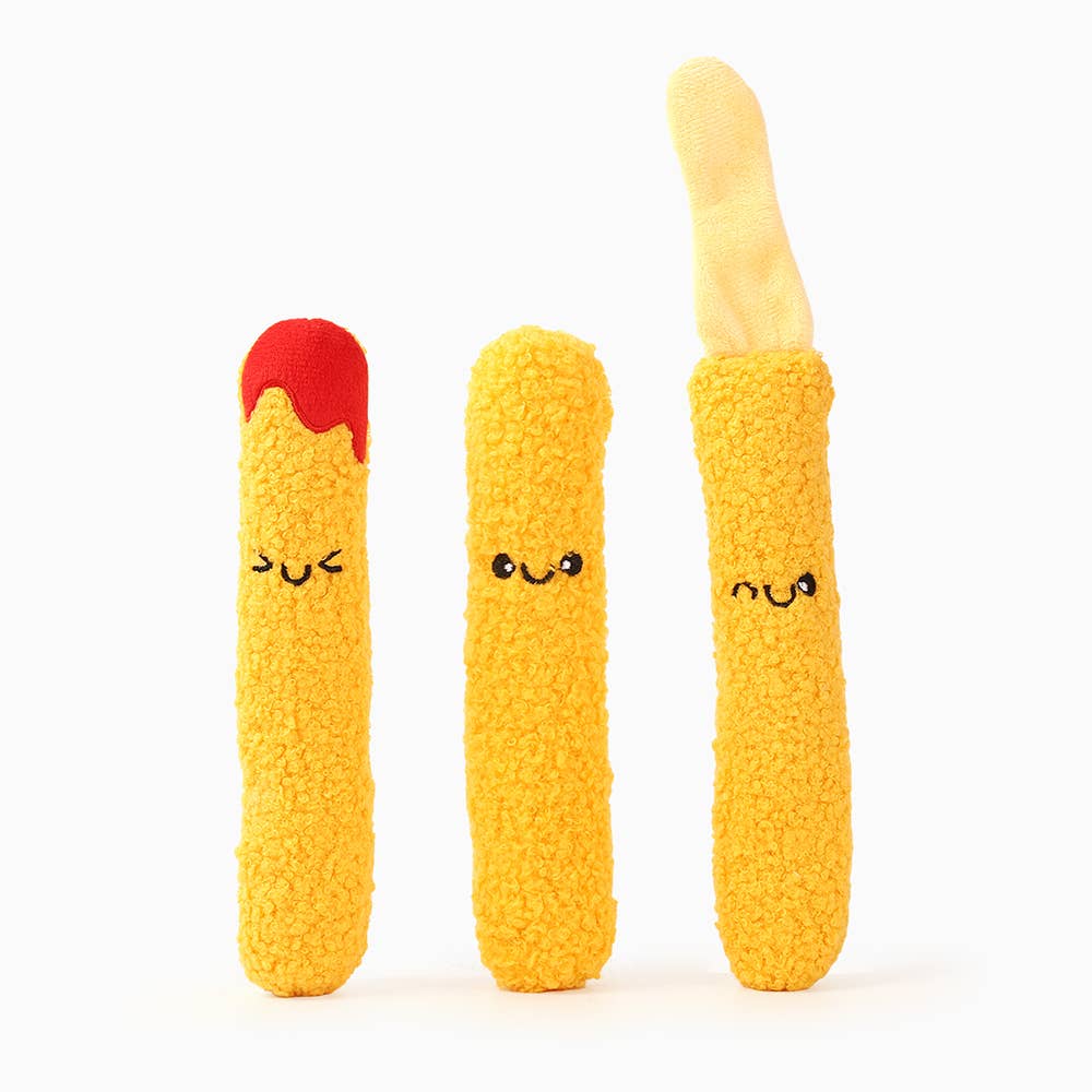 Three plush toys shaped like mozzarella sticks with smiling faces on a white background