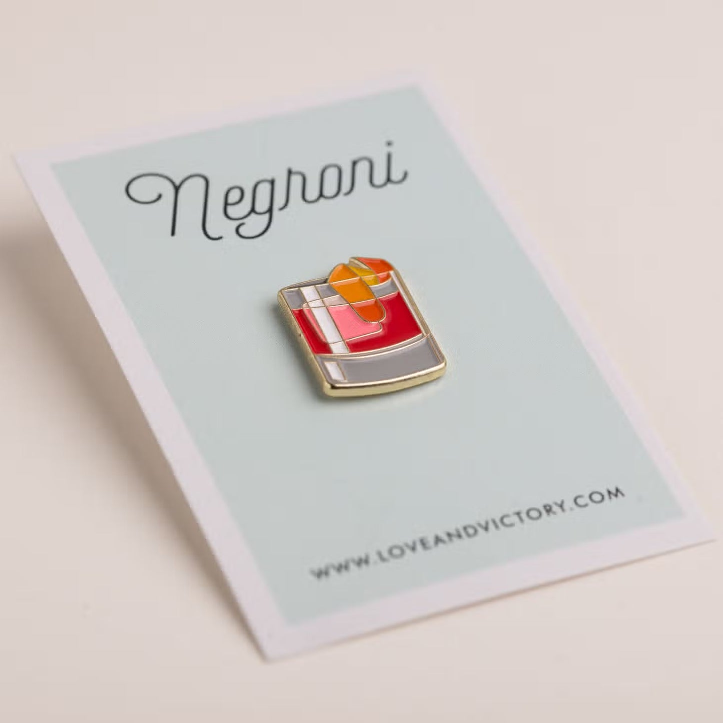 Negroni lapel pin on card backing