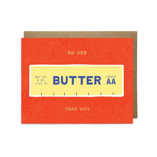 Card with a stick of butter design on a red background