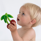 image of a baby holding the cherry teething toy 