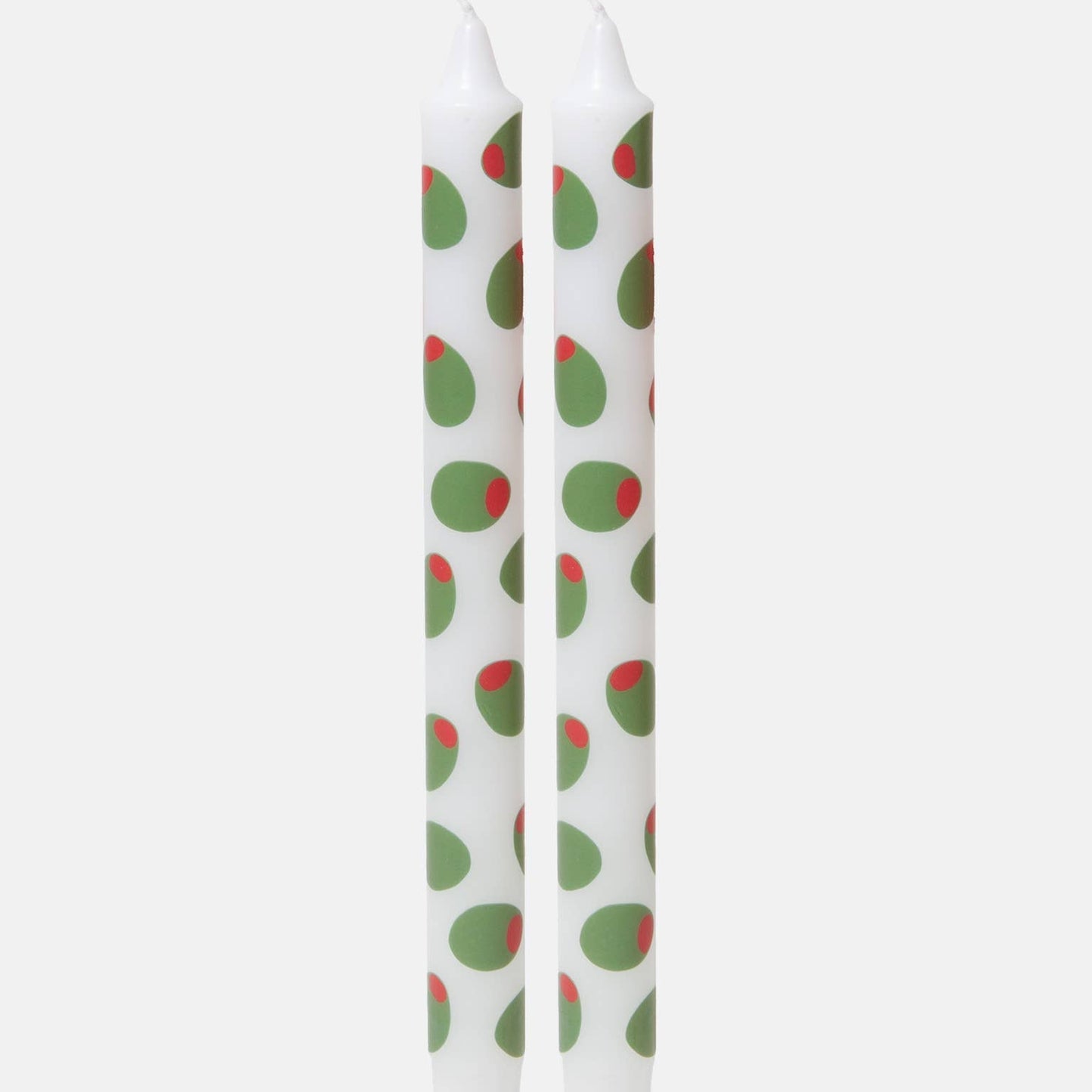 Two white candles with stuffed green olive design pattern on a white background
