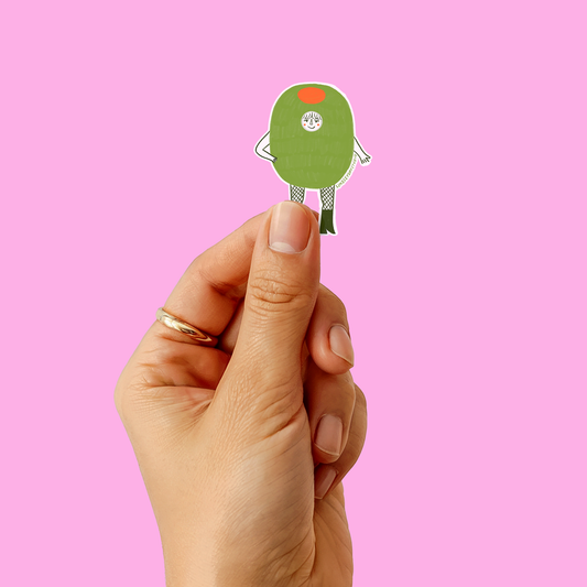 hand holding a sticker of illustration of woman in olive costume