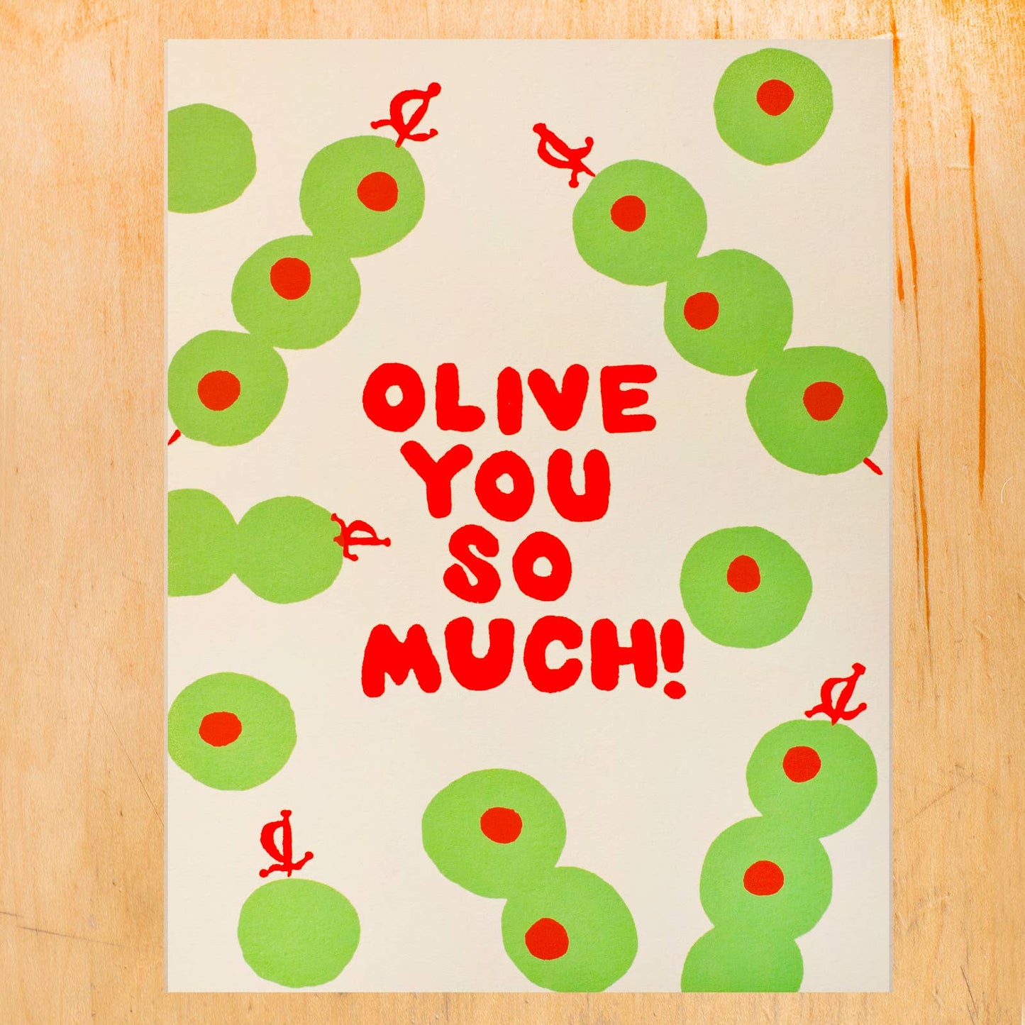 greeting card with cocktail olives all over and red text in the center that reads "olive you so much!"