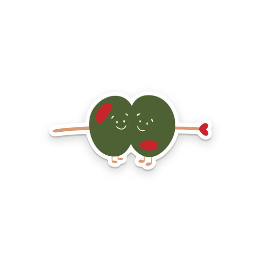 Two cartoonish stuffed green olives on a pick and small legs on a white background