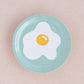 Egg trinket dish. Sunny side up egg on a aqua background.
