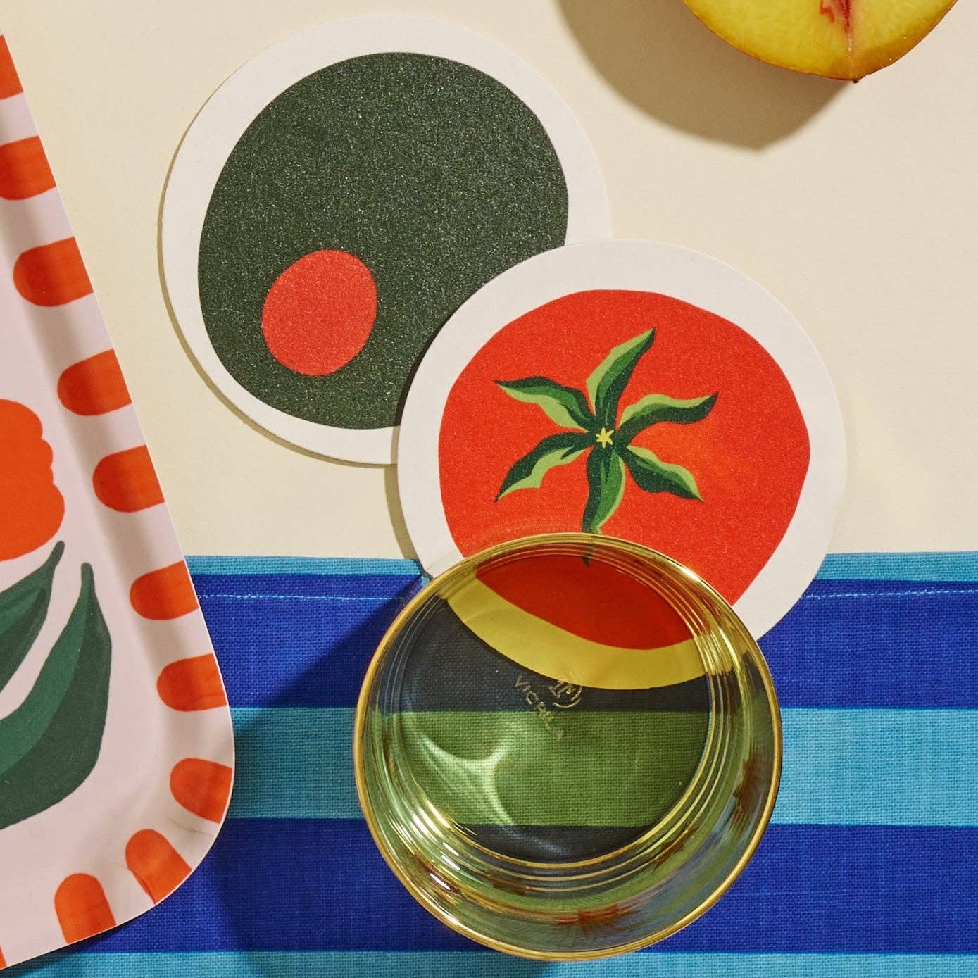 tomato and olive coasters on table 