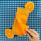 Carton of orange juice illustration on rectangular notepad pictured with orange halves on a blue and white checkered background 