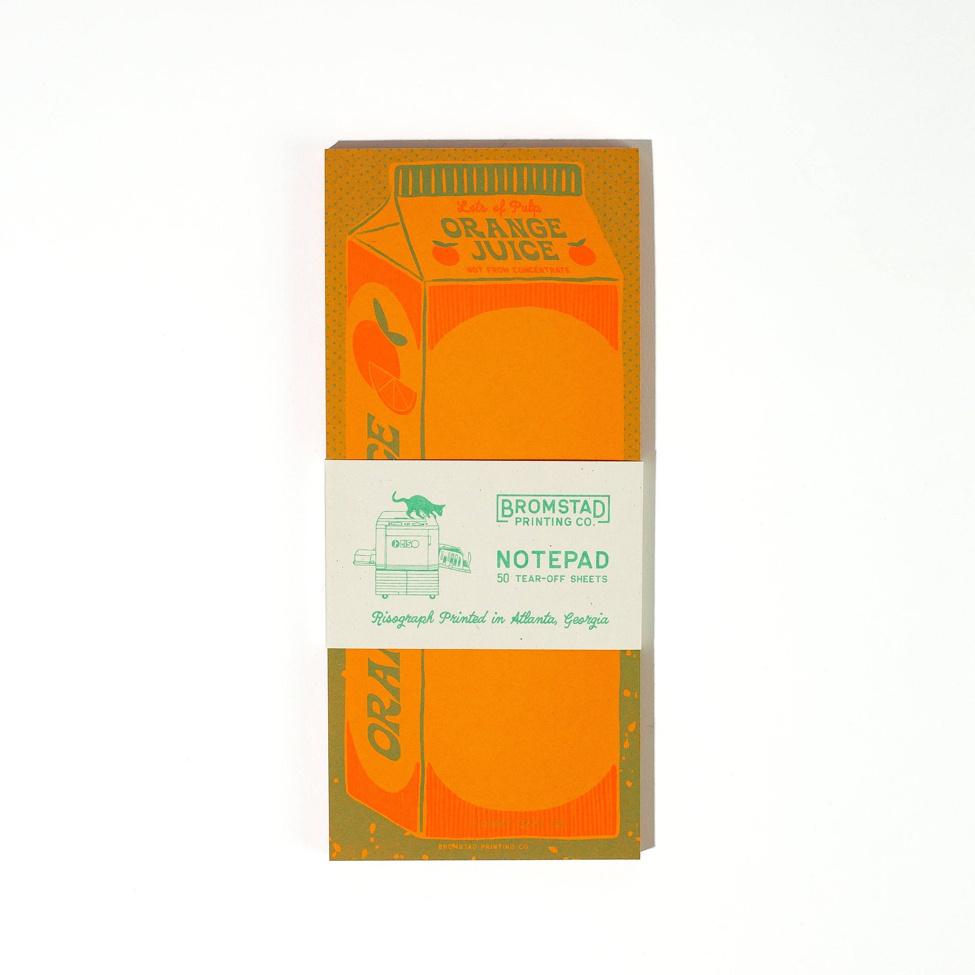 Notepad packaging designed to look like an orange juice carton with 'Bromstad Printing Co.' branding.