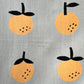 Linen tea towel with oranges screen printed on it. Close up view 
