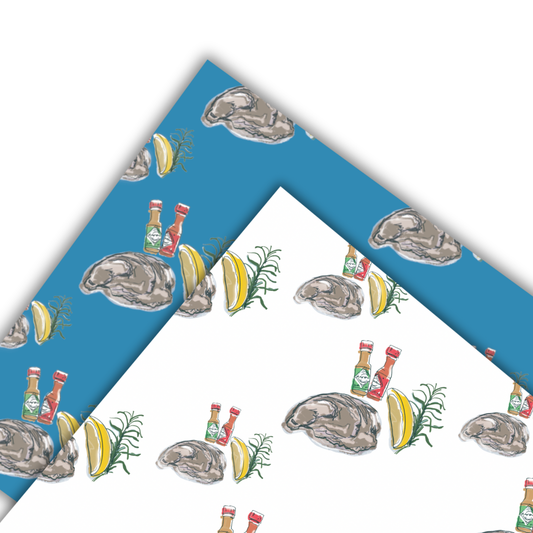 Two sheets of wrapping paper with oyster and lemon design one with a white background and the other a blue 