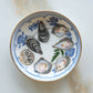 Decorative plate with oyster shells and lemon slices on a white background