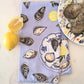 patterned towels with oyster and lemon design on a marble surface with lemons and oysters.