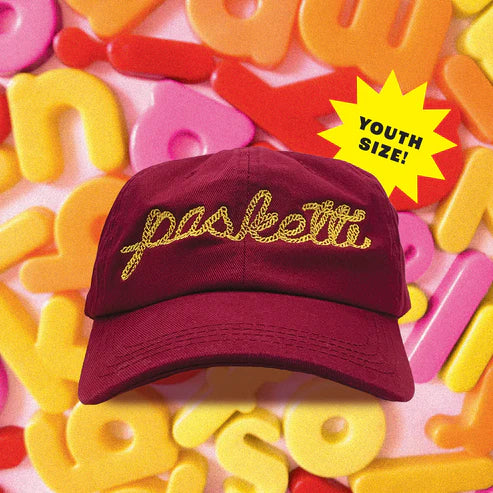 Youth sized hat in marinara red with yellow embroidered text that says "pasketti"