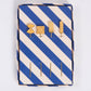 Set of yellow pasta themed cocktail picks in a blue and white striped box