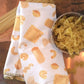 Pasta-themed kitchen towel with a bowl of pasta on a wooden surface