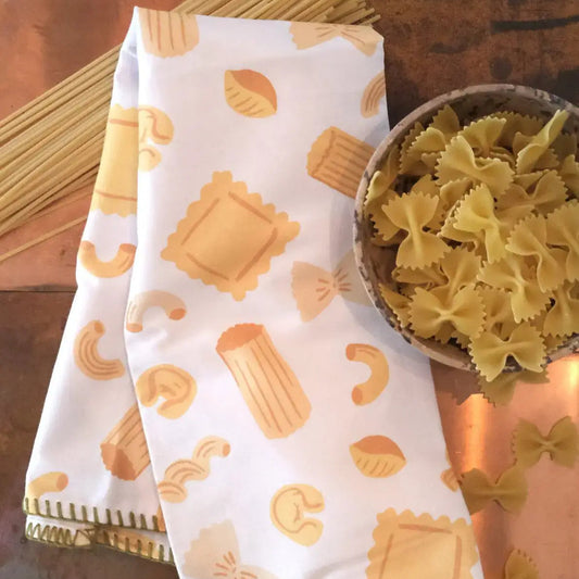 Pasta-themed kitchen towel with a bowl of pasta on a wooden surface